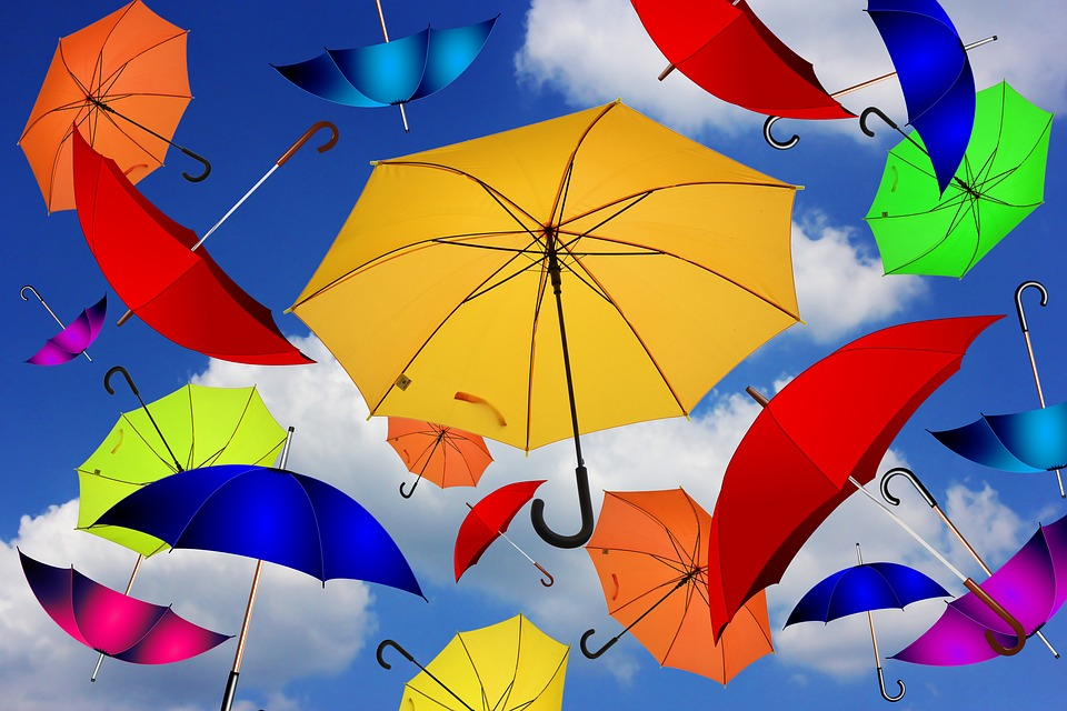 Image of colourful umbrellas that have been thrown in the air.